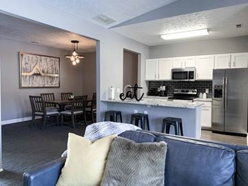 Lincoln apartment for rent - A blue couch with a grey throw blanket and a yellow pillow sits in a living room.