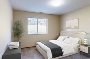 Lincoln apartment for rent - A bedroom with a large bed and a lamp on the nightstand.