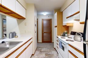 Lincoln apartment for rent - A kitchen with white cabinets and a wooden accent.