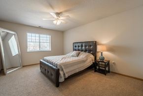 Lincoln apartment for rent - A bedroom with a bed, a nightstand, and a ceiling fan.