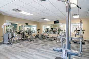 Exteriors-spacious exercise room featuring cardio machines, free weights, and weightlifting machines at