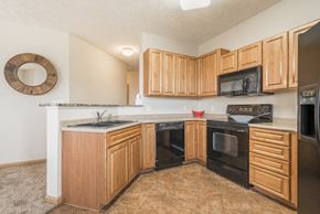 Lincoln triplex for rent - Interiors-Large kitchen with black appliances at Stone Ridge Estates townhomes in South Lincoln