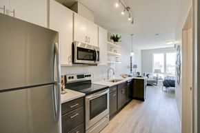 Minneapolis apartment for rent - a kitchen with stainless steel appliances and white cabinets
