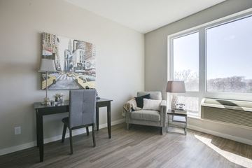 Minneapolis apartment for rent - a living room with a desk and a chair and a window