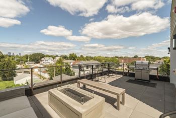 Exteriors relax on the rooftop patio and enjoy the views and warmth of the firepit