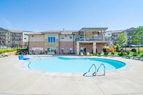Lincoln apartment for rent - our resort style swimming pool with green lounge chairs