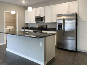 Lincoln apartment for rent - Kitchen with white cabinets and dark granite counters The Flats at Shadow Creek in Lincoln Nebraska