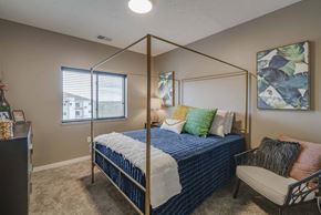 Lincoln apartment for rent - a bedroom with a bed and a chair and a window