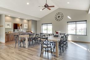 Omaha triplex for rent - a clubhouse room with long tables and chairs for hosting events