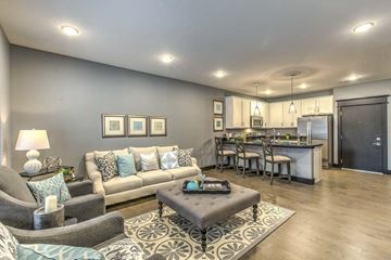 Omaha apartment for rent - a living room and kitchen with a couch and a table