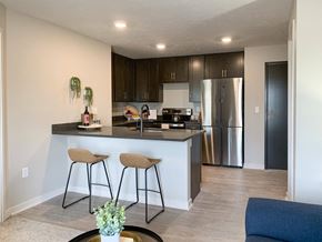 Lincoln apartment for rent - a kitchen with a large island with two stools in front of it