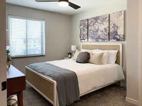 Lincoln apartment for rent - Furnished bedroom with ceiling fan and marbled art above the bed