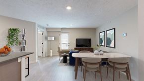Lincoln apartment for rent - A living room and dining space with a TV, chair, couch, and table with four chairs