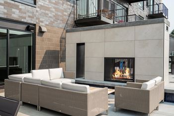 Outdoor amenity deck with multiple conversation areas, firepit, and private grilling areas