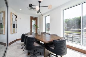 Eagan townhouse for rent - Work from home conference style room with large rectangle table and rolling chairs surrounding the table.
