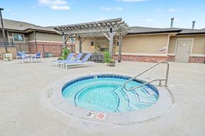 Omaha townhouse for rent - A round above ground pool with a metal railing around it.