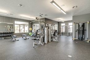 Omaha townhouse for rent - Fitness center with free weights and weightlifting machines at The Villas at Falling Waters townhomes in West Omaha NE