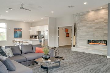 Omaha townhouse for rent - A modern living room with a grey sofa and a fireplace.
