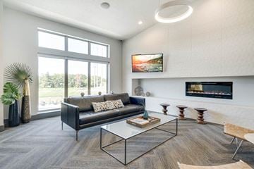 Lincoln townhouse for rent - A modern living room with a black couch and a fireplace.