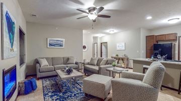 Lincoln townhouse for rent - a living room with couches and chairs and a ceiling fan