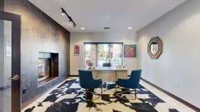 Lincoln townhouse for rent - a office area with a table and chairs and a fireplace at the clubhouse