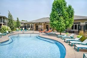 Lincoln townhouse for rent - Organically shaped resort style pool surrounded a pool deck with bright blue lounge chairs