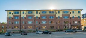 Omaha apartment for rent - The Helen apartment building exterior with street parking