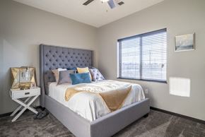 Lincoln townhouse for rent - A bedroom with a large bed and a window with blinds.