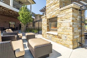 Exteriors-outdoor fireplace with lounge chairs