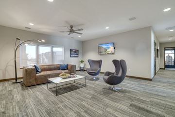 Lincoln apartment for rent - a living room with a couch and chairs and a ceiling fan