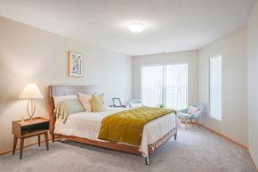 Lincoln apartment for rent - Furnished bedroom with a bed and chairs and a window