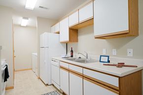 Lincoln apartment for rent - Traditional kitchen with white cabinets, a dishwasher, a sink and a refrigerator