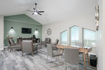 La Vista townhouse for rent - a living room with a table and chairs and a ceiling fan