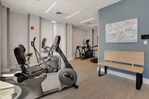 Frederick apartment for rent - a room filled with exercise equipment and a bench