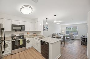 Clarksburg apartment for rent - A modern kitchen with white cabinets and stainless steel appliances.