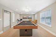 Clarksburg apartment for rent - A pool table is in the middle of a room with a picture on the wall and a window with blinds.