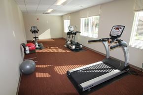Odenton apartment for rent - A gym with a treadmill, exercise bike, and other equipment.