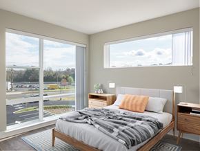 Clinton apartment for rent - a bedroom with a large window and a bed with a blanket