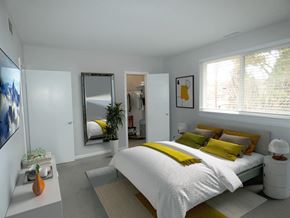 Baltimore apartment for rent - a bedroom with white walls and a yellow and white bedspread