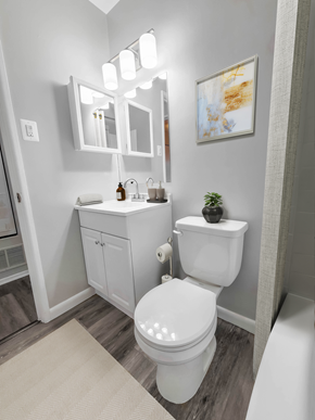 Baltimore apartment for rent - a bathroom with a toilet sink and bathtub in a 555 waverly unit