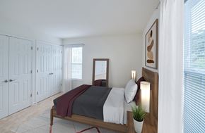Frederick townhouse for rent - a bedroom with white walls and a bed with a wooden frame