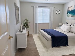 Annapolis apartment for rent - a bedroom with a bed and a clock on the wall