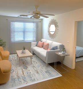 Odenton apartment for rent - A living room with a white couch, a yellow chair, and a rug.