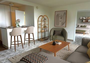 Rockville apartment for rent - A living room with a brown wooden coffee table and a grey sofa.