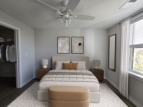 Prince Frederick apartment for rent - A bedroom with a large bed and a ceiling fan.