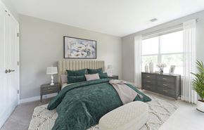 Lusby apartment for rent - a bedroom with a bed and a dresser and a window