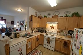 Prince Frederick apartment for rent - a kitchen with white appliances and wooden cabinets