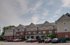 Prince Frederick apartment for rent - a parking lot in front of an apartment building with cars parked in front