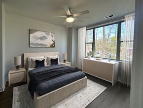 Rockville apartment for rent - A bedroom with a large bed and a painting on the wall.