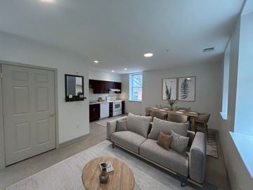 Baltimore apartment for rent - A living room with a grey couch and a wooden coffee table.